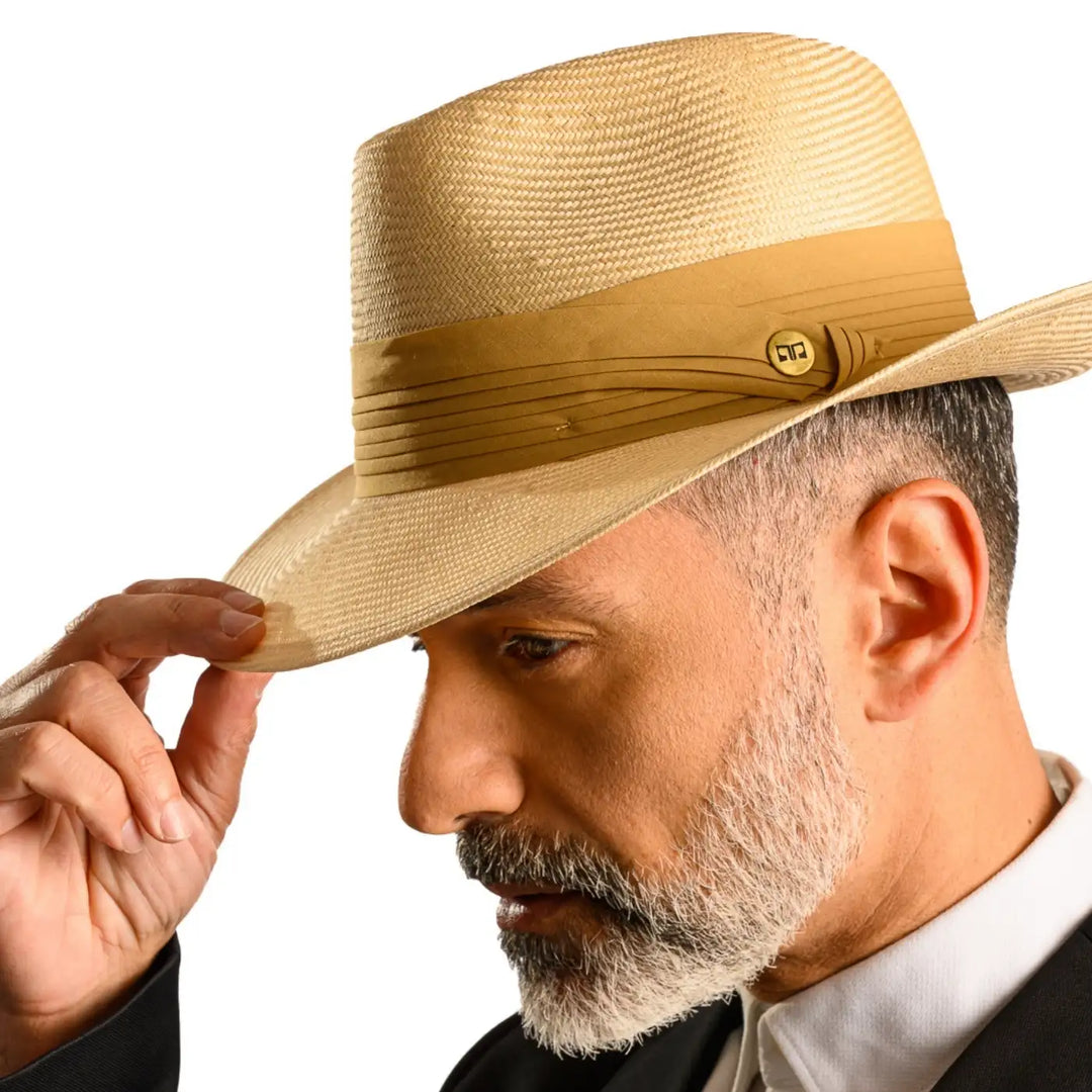 primo piano laterale ravvicinato di uomo con barba che indossa un cappello fedora elegante in parasisol color camel realizzato da cappelleria primario nesti