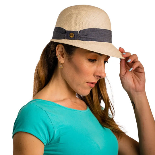 vista laterale inclinata di una donna con capelli lunghi che indossa un cappello di panama con visiera corta color bianco fatto a mano da cappelleria primario nesti